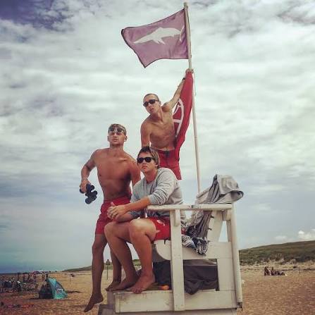 There will usually be a red flag with a shark on it if there is a fin in the water